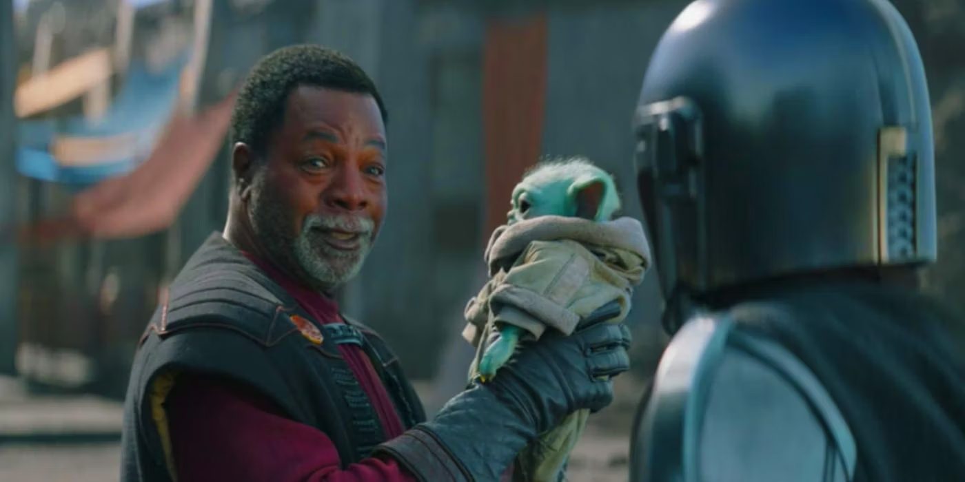 Greef Karga holding Grogu Mandalorian 1